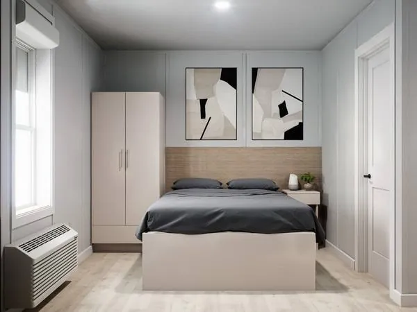Bedroom with a made bed and wardrobe