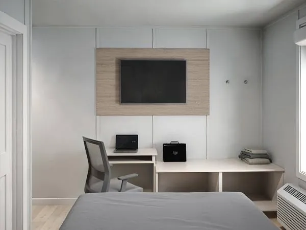 Suite workstation with desk, chair, and wall-mounted TV